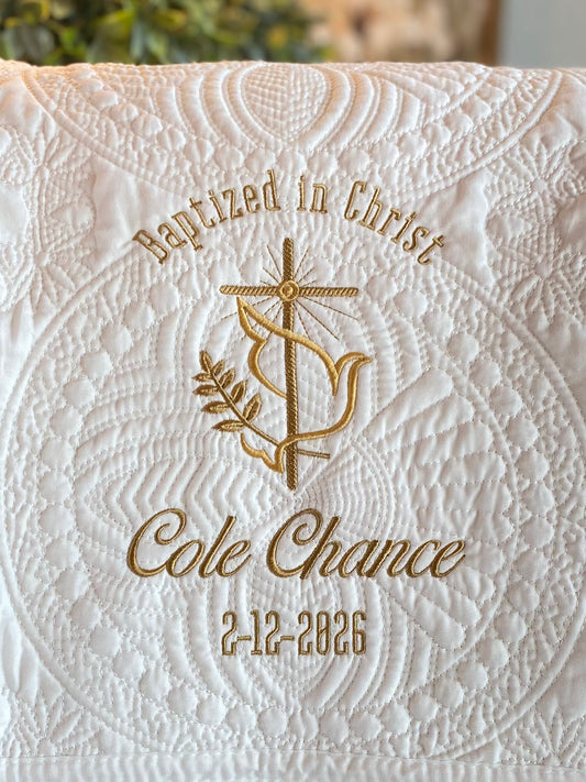 Personalized Baptized in Christ Dove & Cross Baby Quilt | Custom Name & Date Christening Heirloom Blanket with elegant gold embroidery on white quilted fabric featuring dove, cross, and custom text.