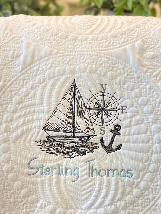 Personalized Embroidered Sailboat Compass & Anchor Baby Quilt | Custom Name Heirloom Blanket featuring detailed sailboat, compass, and anchor embroidery with a custom name on a soft quilted fabric.