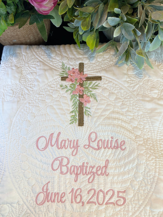 Personalized Rustic Cross Pink Floral Baptism Baby Quilt | Custom Name & Date Christening Heirloom Blanket featuring an embroidered cross with pink flowers and green leaves, custom name and baptism date in elegant script on a textured white quilt.