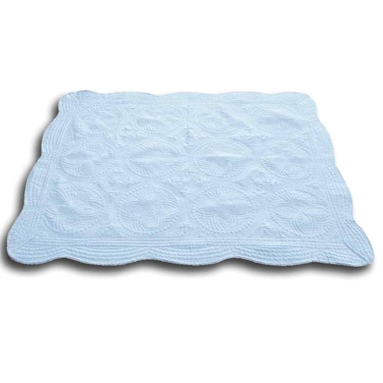 Personalized Bow Monogram Baby Quilt | Custom Name Pink Heirloom Blanket displayed in white textured fabric with intricate quilted patterns and scalloped edges.