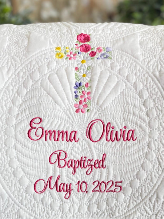 Personalized Garden Floral Cross Baptism Baby Quilt | Custom Name & Date Christening Heirloom featuring embroidered floral cross and custom name with baptism date on a white quilted background.
