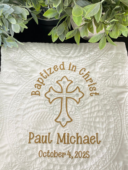 Personalized Baptized in Christ Ornate Cross Baby Quilt | Custom Name & Date Christening Heirloom Blanket featuring elegant embroidered cross, name, and date on a textured white quilt.