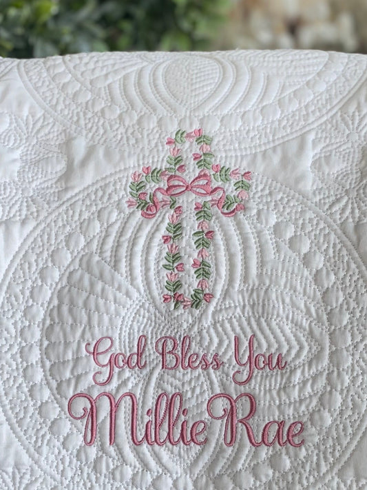 Personalized God Bless You Floral Vine Cross Baptism Baby Quilt | Christening Heirloom Keepsake featuring elegant white quilting with a pink and green floral cross and custom embroidered name Millie Rae.