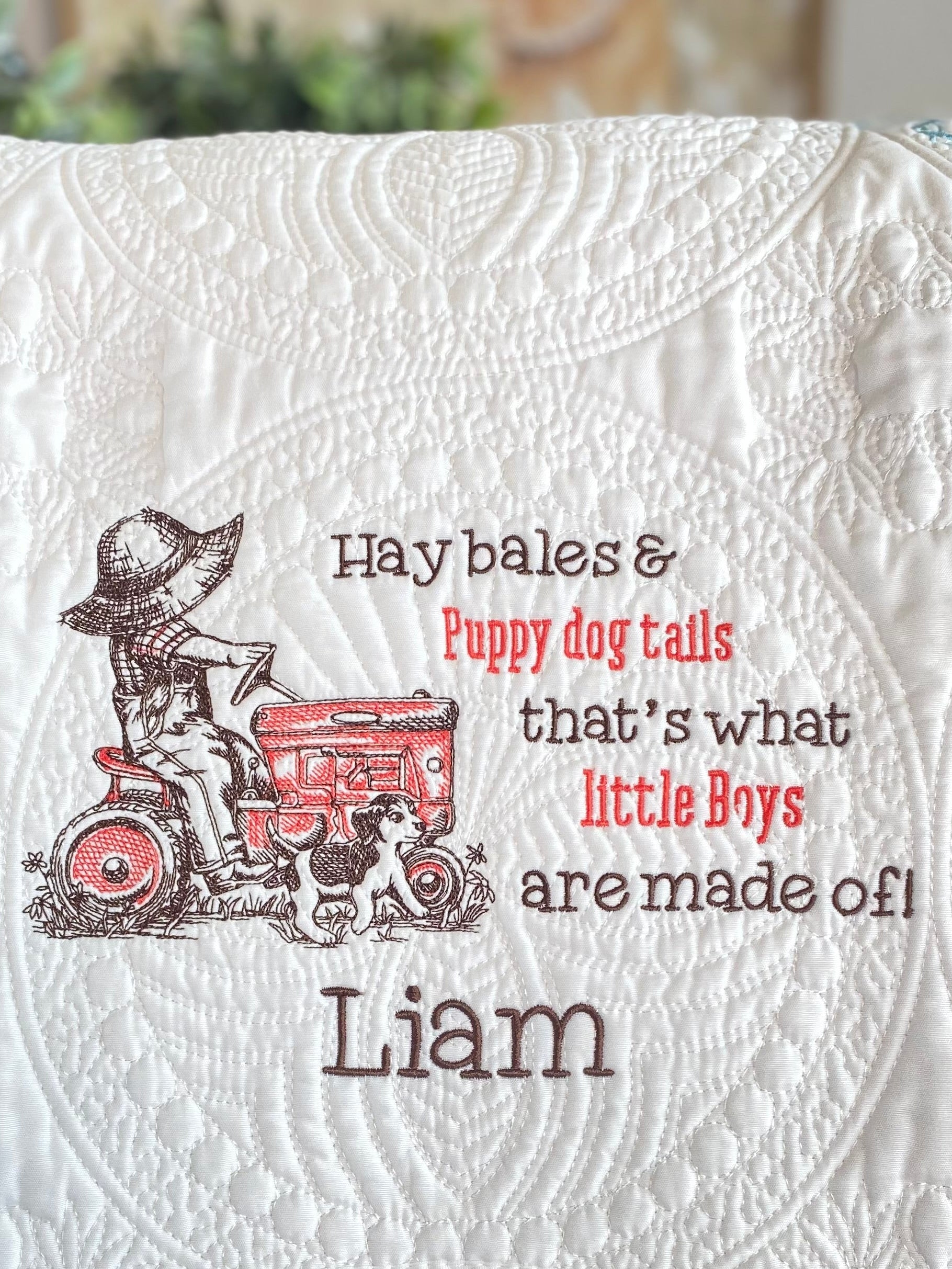 Personalized Little Tractor Boy & Puppy Baby Quilt | Custom Name Heirloom Blanket for Boys featuring embroidered design of a boy on a red tractor with a puppy and the name Liam.