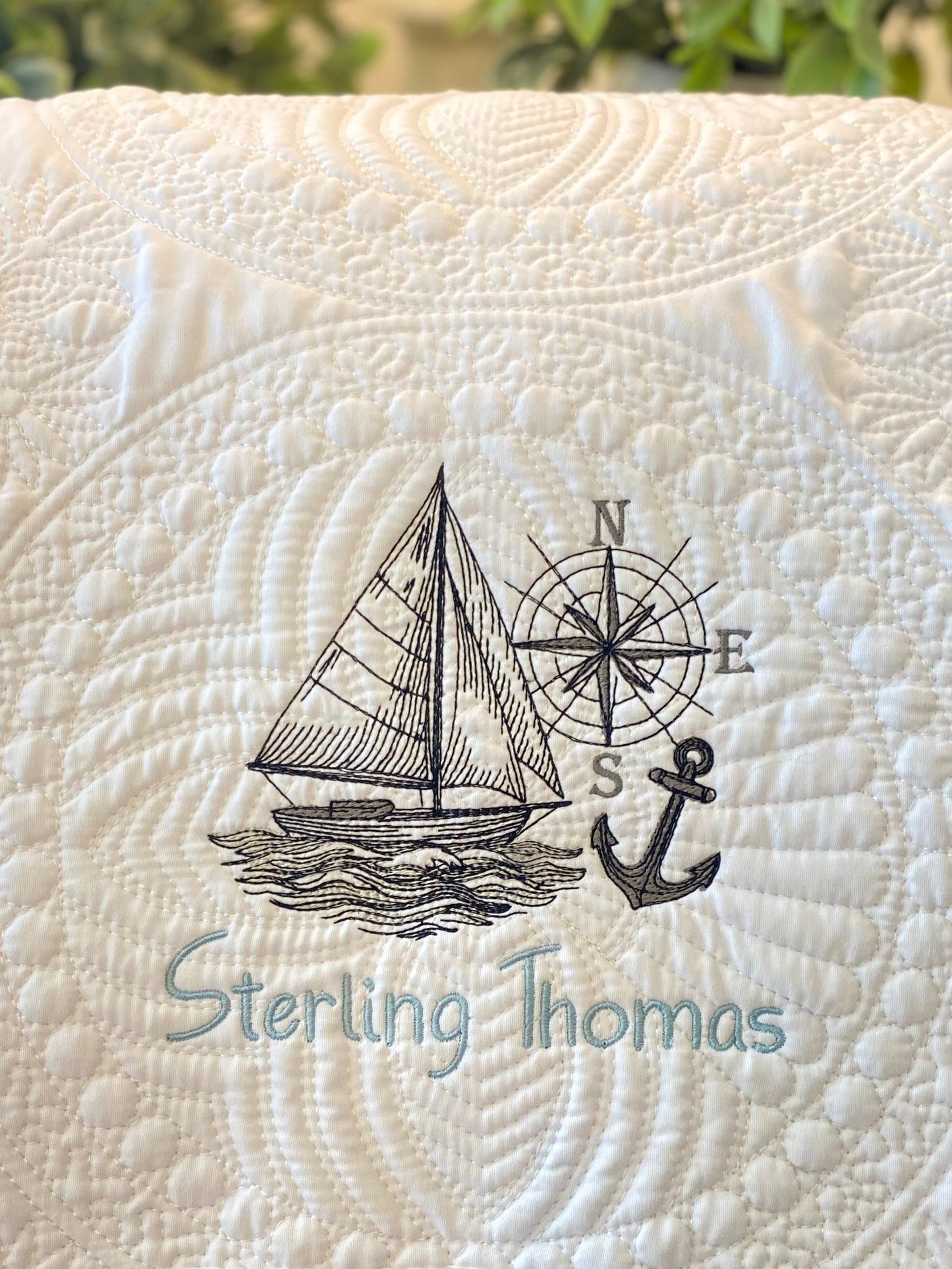 Personalized Embroidered Sailboat Compass & Anchor Baby Quilt | Custom Name Heirloom Blanket featuring detailed sailboat, compass, and anchor embroidery with a custom name on a soft quilted fabric.