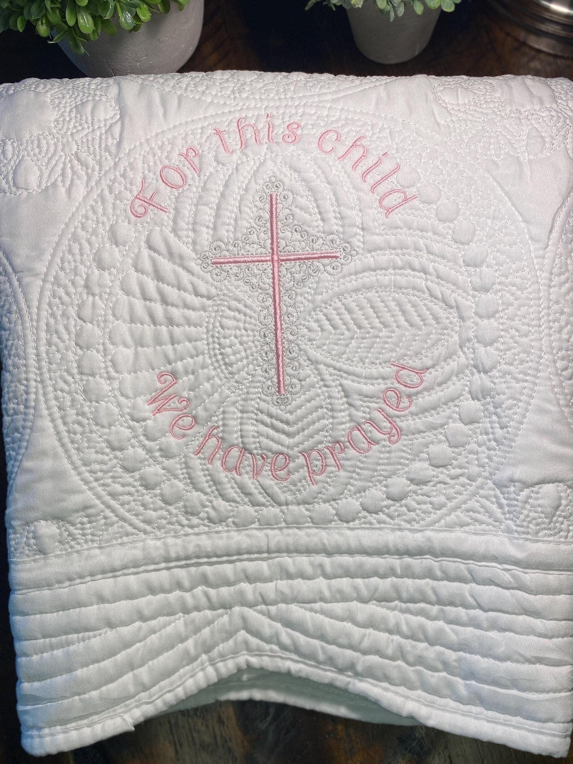 For This Child We Have Prayed" Cross Baby Quilt | Custom Embroidered Baptism Heirloom Blanket featuring delicate white quilting with a pink embroidered cross and script, perfect personalized baby gift.
