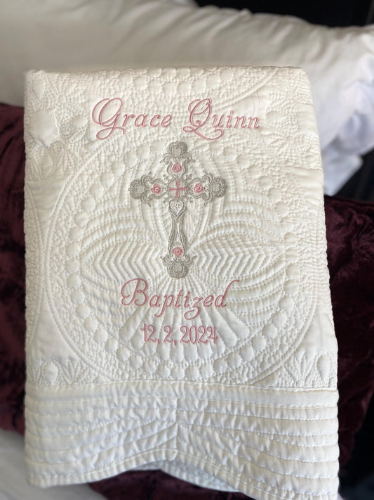 Personalized Baptism Baby Quilt | Custom Cross Christening Heirloom Blanket featuring intricate embroidery with a cross, custom name, and baptism date on a white quilted fabric.