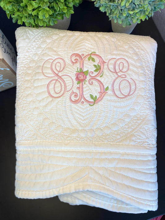 Personalized Vintage Rose Monogram Baby Quilt | Custom Embroidered Heirloom Blanket featuring detailed floral embroidery with monogrammed initials on a textured cream quilt, perfect heirloom baby gift.