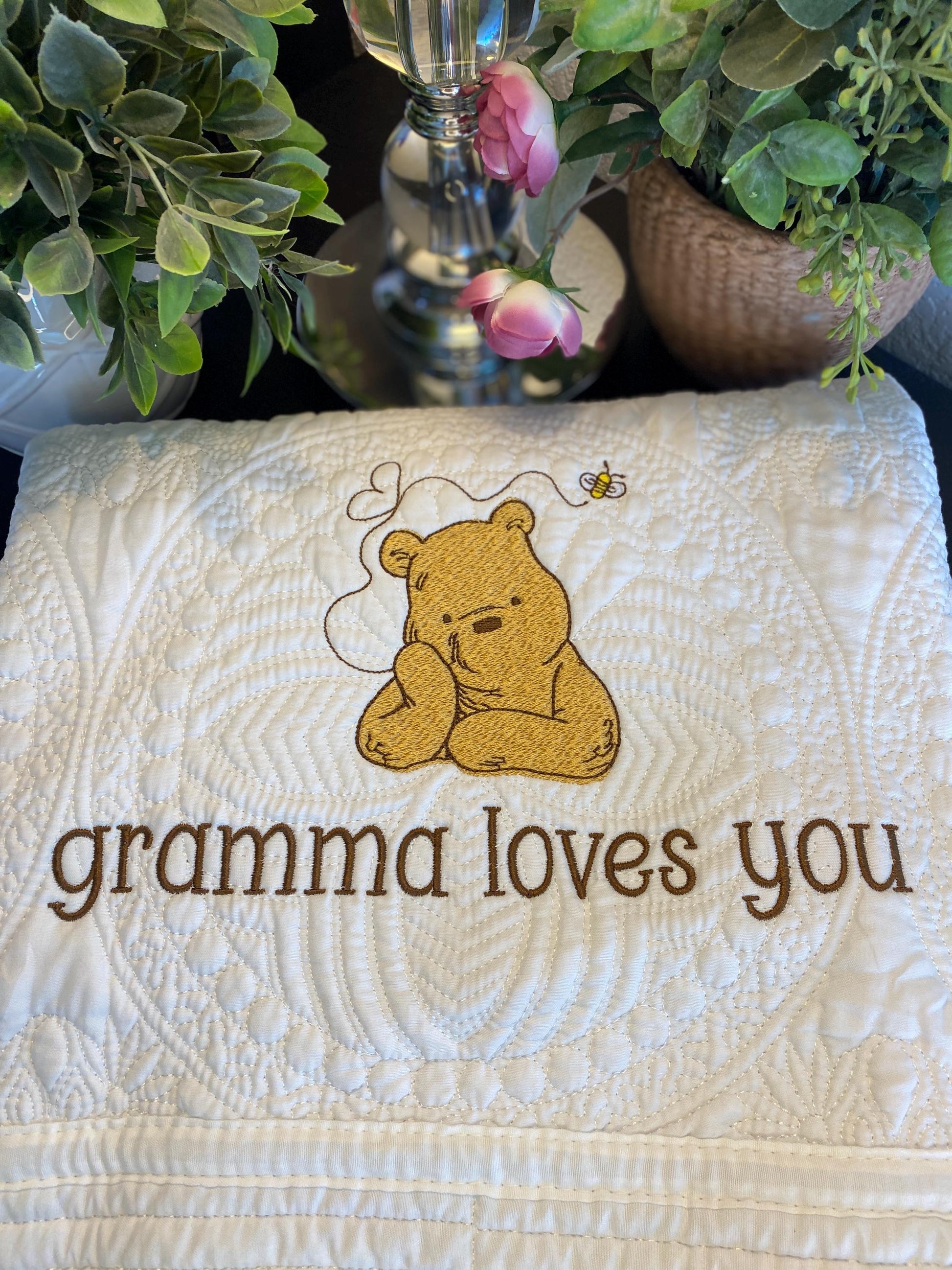 Personalized Storybook Bear Honey Bee Baby Quilt | Custom Name Heirloom Keepsake featuring an embroidered bear and bee with the message "gramma loves you" on a soft, quilted baby blanket.