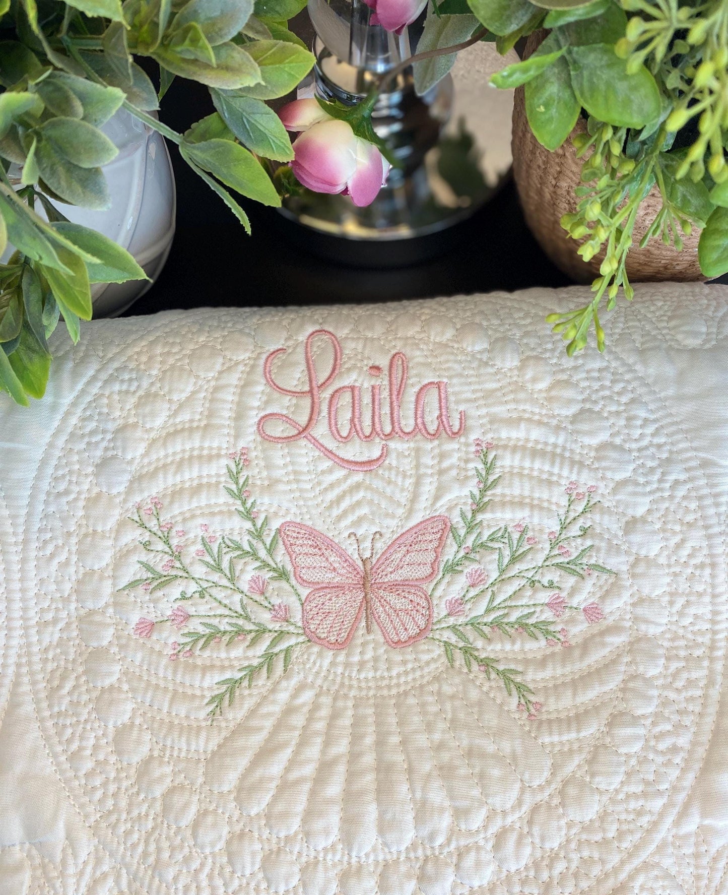 Personalized Pink Butterfly & Botanical Baby Quilt | Custom Name Heirloom Blanket for Girls featuring delicate pink butterfly and floral embroidery with the name Laila embroidered in elegant script.