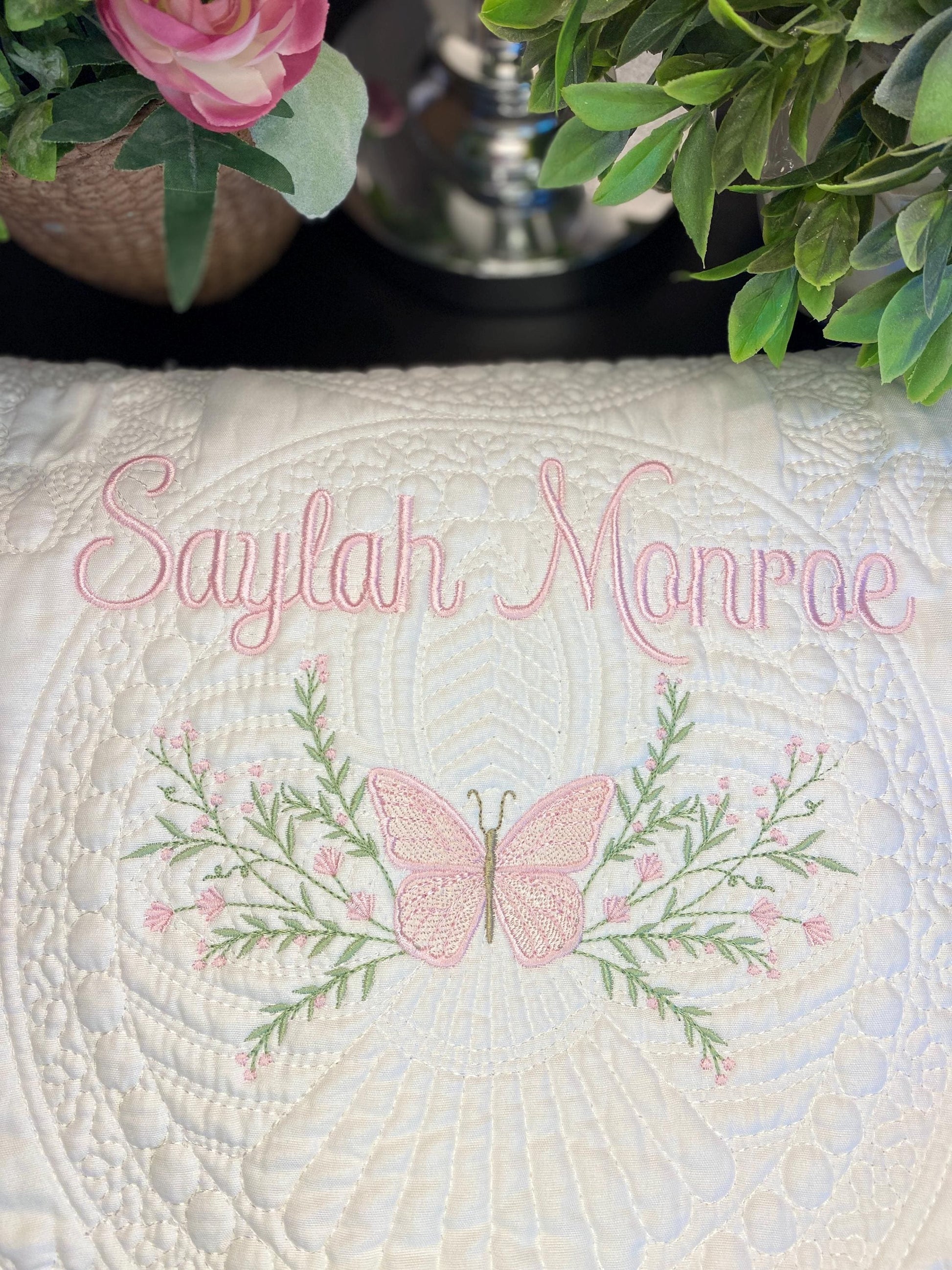 Personalized Pink Butterfly & Botanical Baby Quilt | Custom Name Heirloom Blanket for Girls featuring delicate pink butterfly embroidery, floral greenery, and elegant custom name stitching.