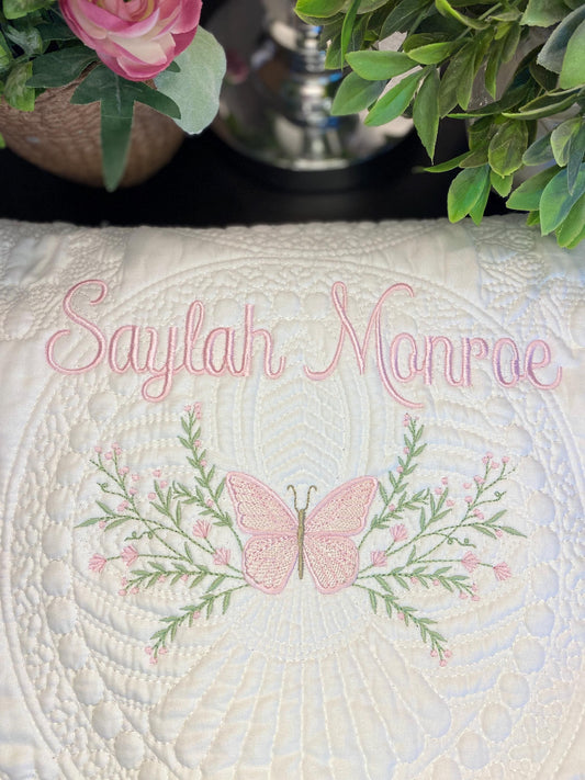 Personalized Pink Butterfly & Botanical Baby Quilt | Custom Name Heirloom Blanket for Girls featuring delicate pink butterfly embroidery, floral greenery, and elegant custom name stitching.