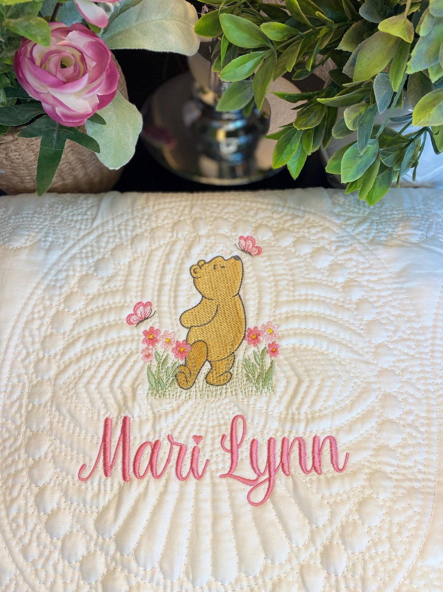 Personalized Storybook Bear Pink Flowers & Butterflies Baby Quilt | Custom Name Heirloom Keepsake featuring an embroidered bear, pink flowers, butterflies, and custom name Mari Lynn in pink script.