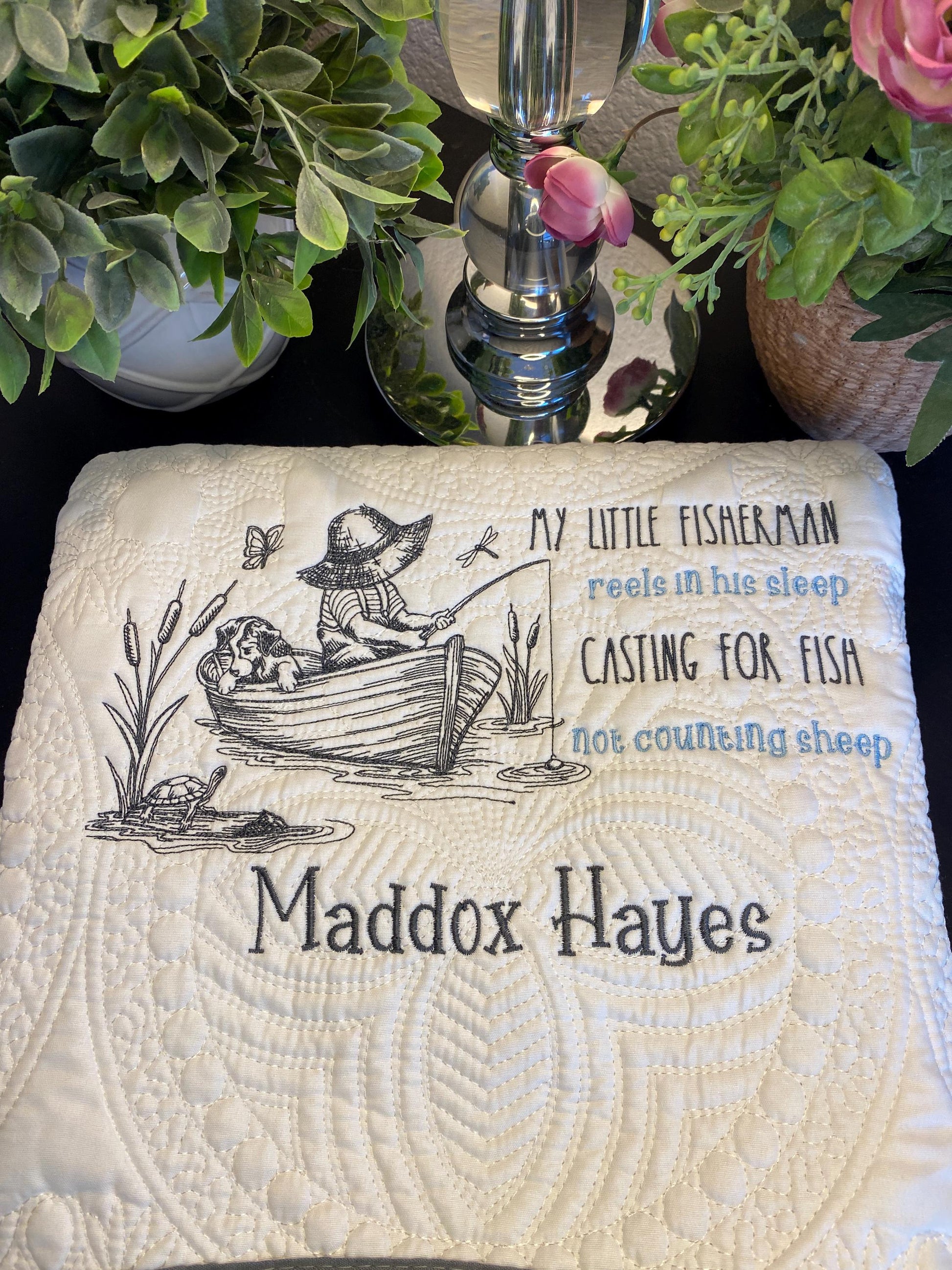 Personalized Little Fisherman Boy & Dog Baby Quilt | Custom Name Heirloom Blanket for Boys featuring a child fishing in a boat with a dog, embroidered with the name Maddox Hayes.