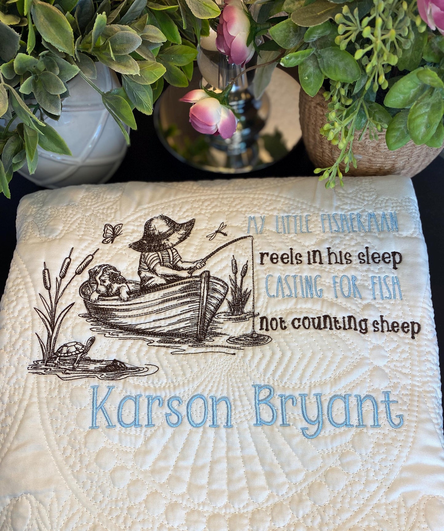 Personalized Little Fisherman Boy & Dog Baby Quilt | Custom Name Heirloom Blanket for Boys featuring a boy fishing with a dog in a boat, embroidered with name Karson Bryant and whimsical text about fishing.