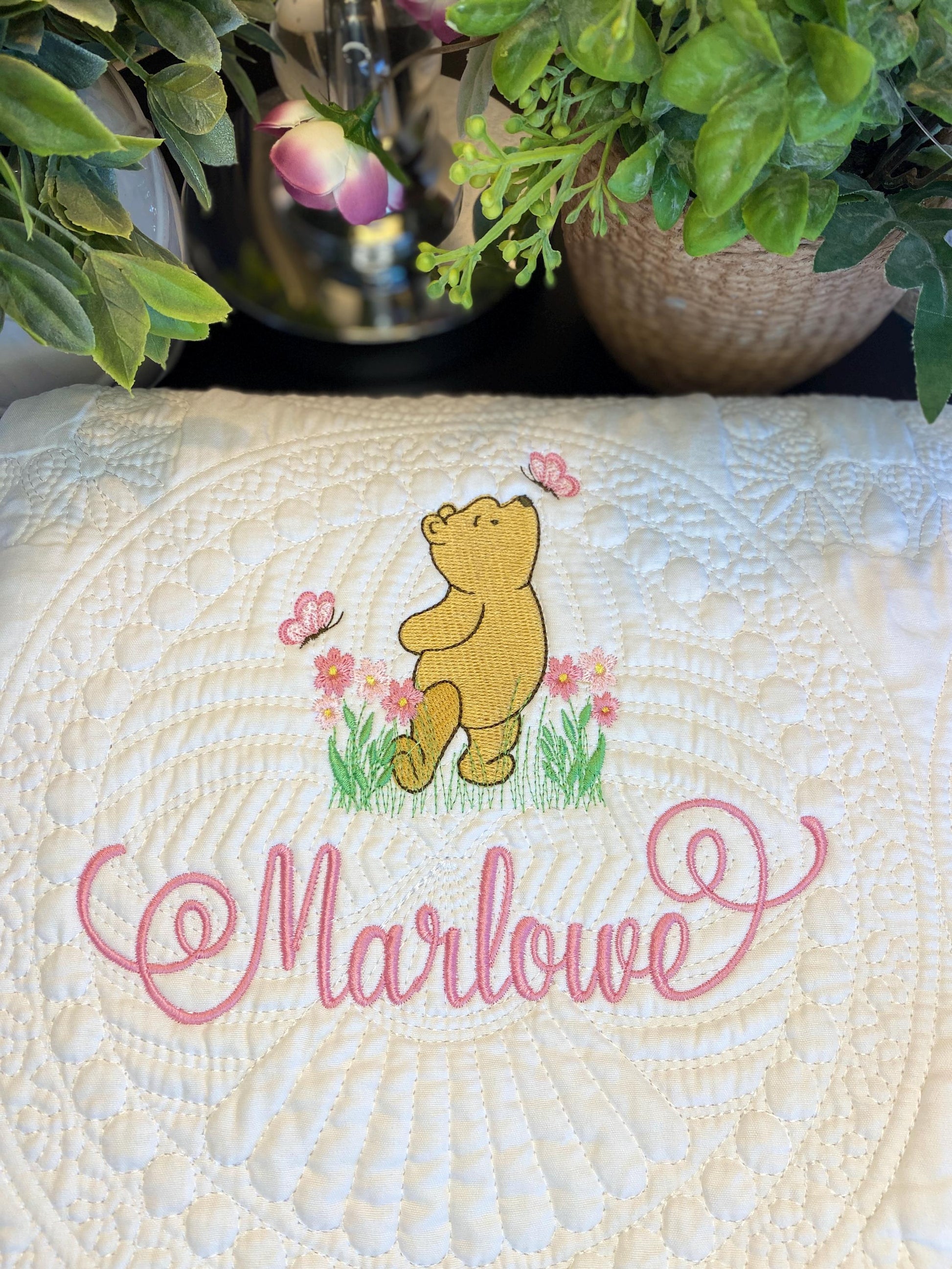 Personalized Storybook Bear Pink Flowers & Butterflies Baby Quilt | Custom Name Heirloom Keepsake featuring embroidered bear with pink butterflies and flowers, custom name Marlowe.