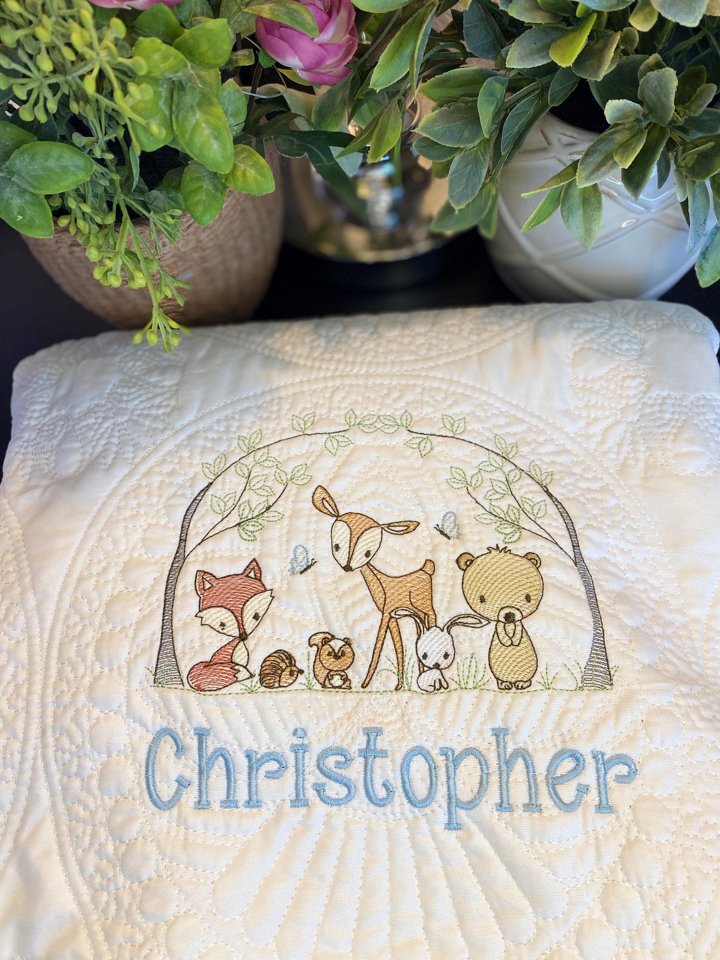 Personalized Woodland Animals Baby Quilt | Custom Name Heirloom Blanket for Boys & Girls featuring embroidered forest animals and a custom name on a soft, textured cream quilt.