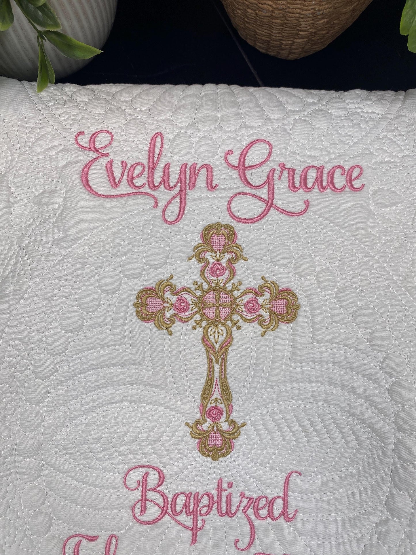 Personalized Baptism Baby Quilt | Custom Cross Christening Heirloom Blanket with intricate white quilting, pink embroidered name Evelyn Grace, and ornate gold and pink cross design.
