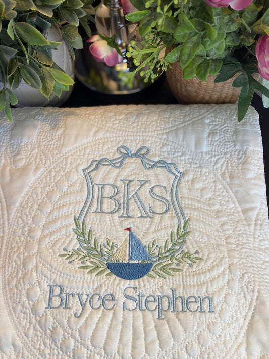 Personalized Sailboat Crest Monogram Baby Quilt | Custom Embroidered Heirloom Blanket for Boys featuring a detailed sailboat, monogram initials BKS, and the name Bryce Stephen in soft blue and green embroidery.