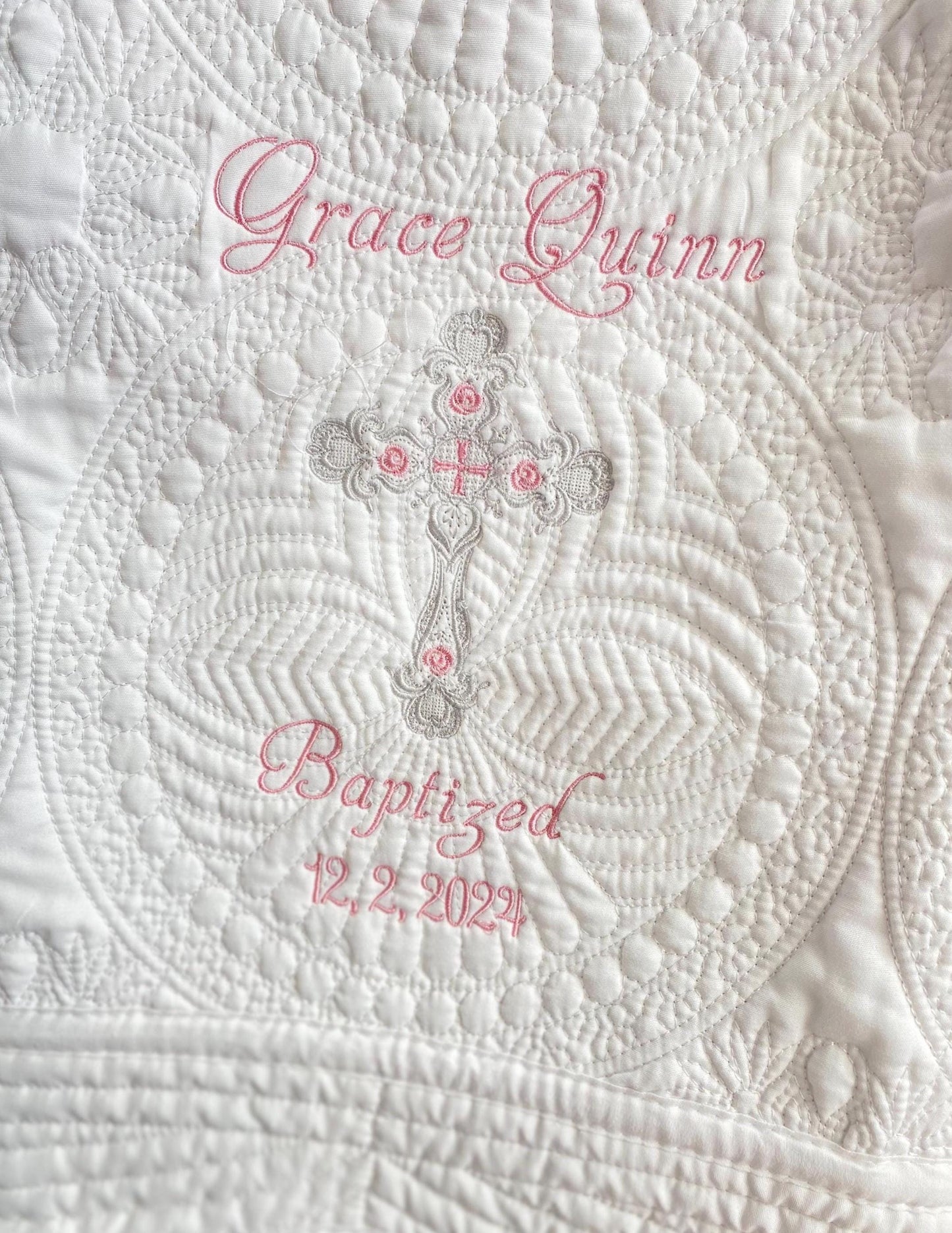 Personalized Baptism Baby Quilt | Custom Cross Christening Heirloom Blanket featuring delicate white quilting with an embroidered cross and custom name and date in soft pink thread, perfect heirloom baby gift.