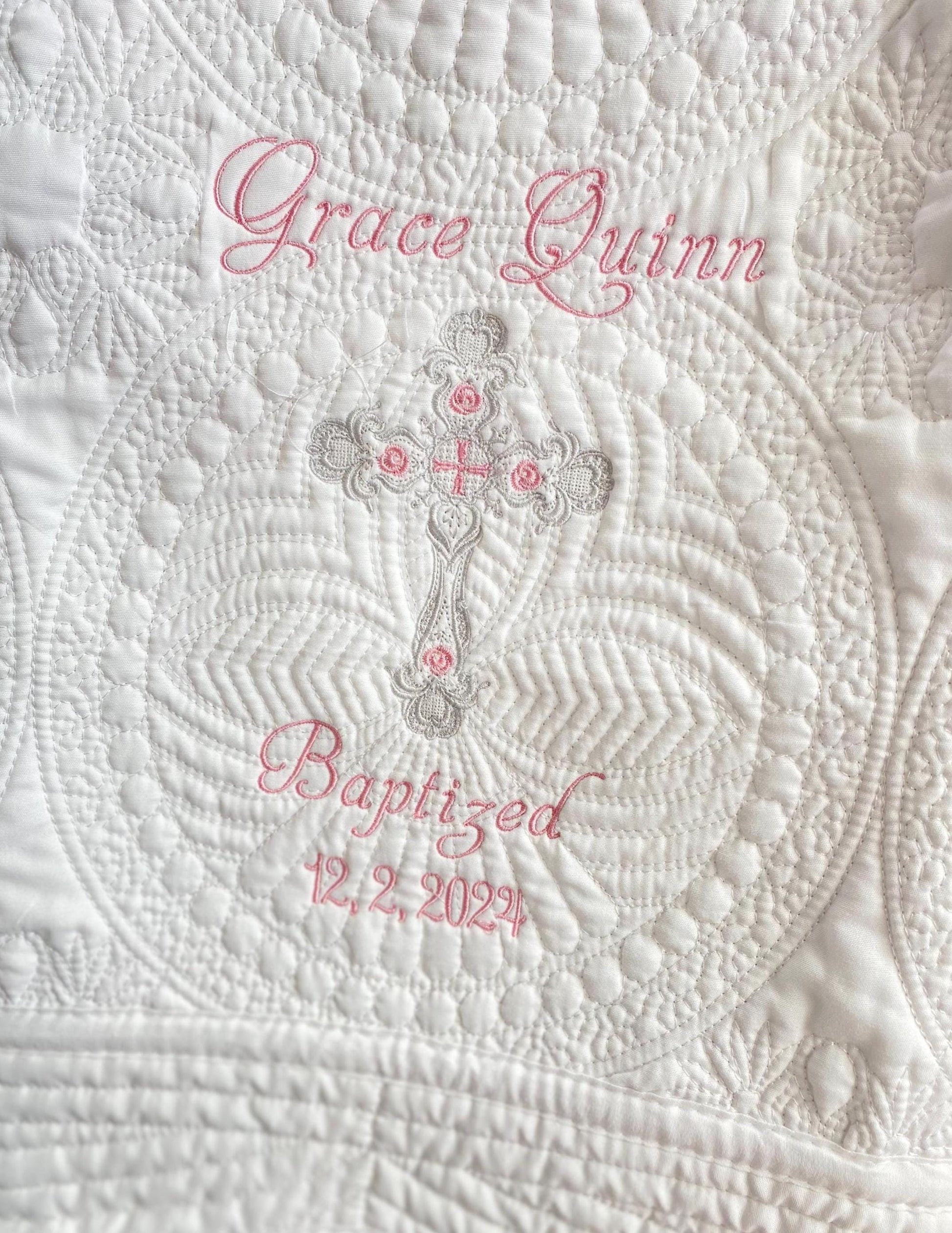 Personalized Baptism Baby Quilt | Custom Cross Christening Heirloom Blanket featuring delicate white quilting with an embroidered cross and custom name and date in soft pink thread, perfect heirloom baby gift.