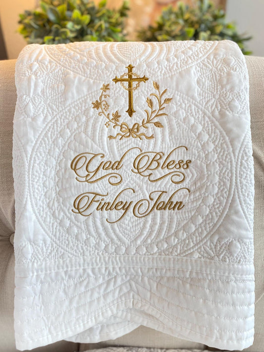 White Personalized Embroidered Baptism Baby Quilt | Custom Cross Christening Blanket | Religious Keepsake featuring gold embroidered cross, floral design, and "God Bless Finley John" text on quilted fabric.